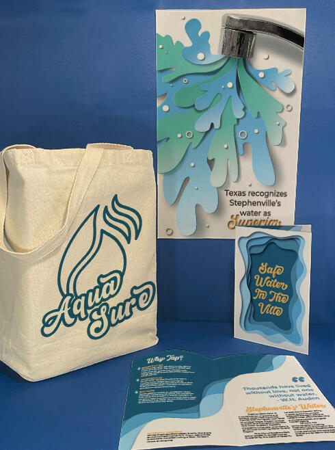 A mockup displaying a poster with a paper-cut illustration of water coming out of a faucet, a tote bag with a water-drop logo and the words Aqua Sure, and two brochures, one open and one closed, with a blue and white paper-cut design.